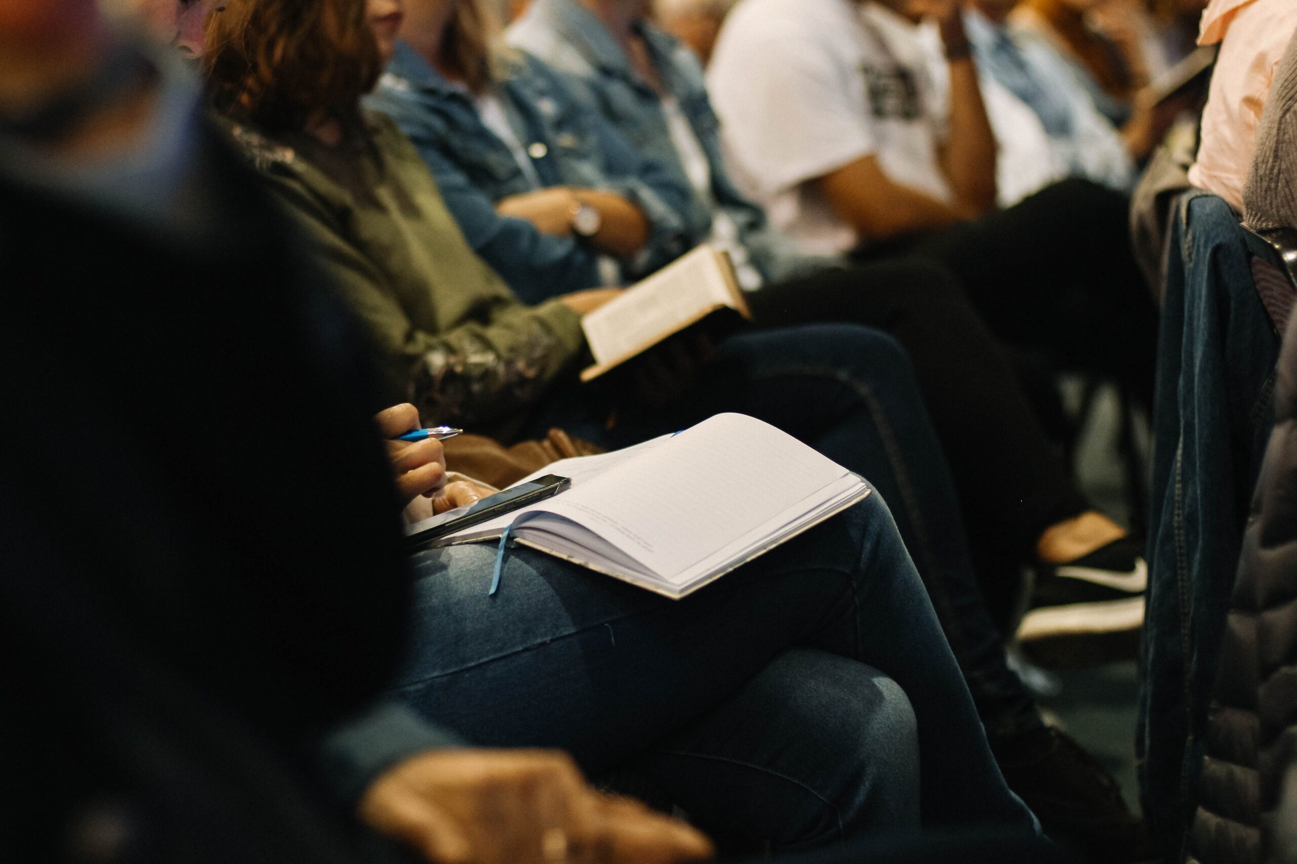 people sitting with notebooks open on lap